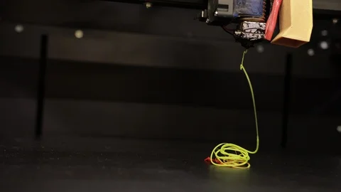 3D technology the printer prints part from plastic cable thread close up yellow Stock Footage 124716027