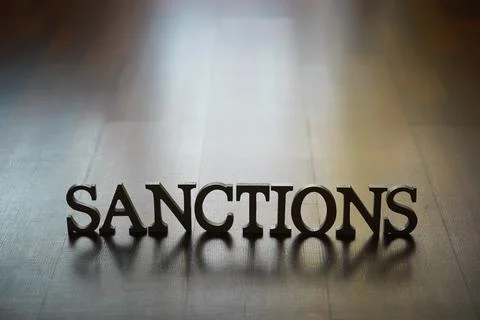 3D Word "Sanctions" on Reflective Surface with Dark Background Stock Photos
