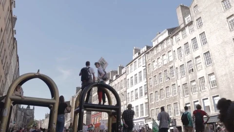 3ed Global Climate Strikes: Students Holding Signs Climbing Onto Arch Edinburgh Stock Footage 117187272