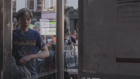 3ed Global Climate Strikes: Students Marching Edinburgh View Through Bus Stop Stock Footage 117187312