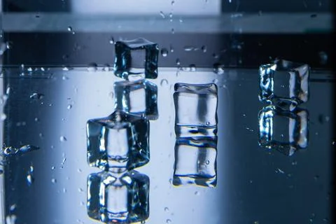 3.Multiple Ice Cubes on a Wet Reflective Surface Stock Photos