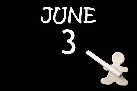 3rd day of June. A small white plasticine man writing the date 3 June on a bl Stock Photos