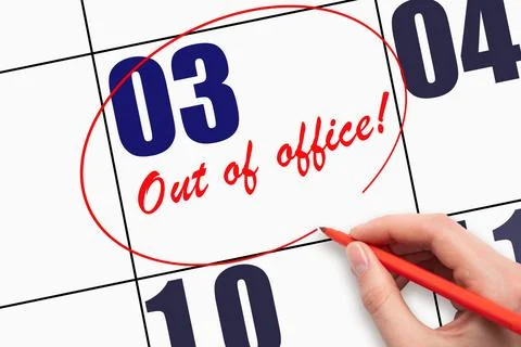 3rd day of the month.  Hand writing text OUT OF OFFICE and circling the cal.. Stock Photos