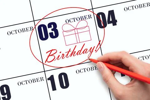 3rd day of October. The hand circles the date on the calendar 3 October, draw Stock Photos