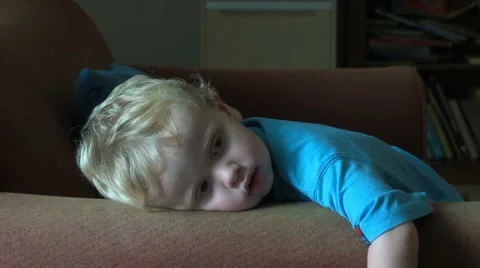 3yo boy watching tv on sofa Stock Footage 1065089