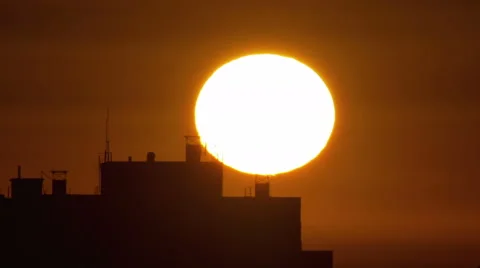4 in 1 video! The sunrise above city buildings roof - extreme close up Stock Footage