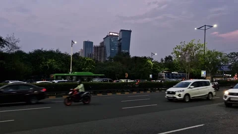 4-7-24; Traffic flows in the left lane with Noida buildings visible in evening. Stock-Footage 279175054
