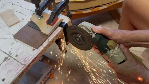 4 Close up of worker cutting metal piece with angle grinder tool in workshop Stock Footage 343421780