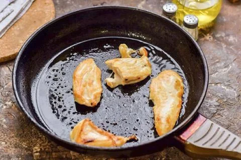 4. Cook the fillets on each side for 3-4 minutes. Stock Photos