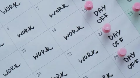 4 day work week printed calendar with pink pins on three days off in week Stock Footage 241467821