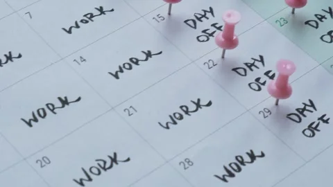 4 day work week printed calendar with pink pins on three days off in week Stock Footage 246461364