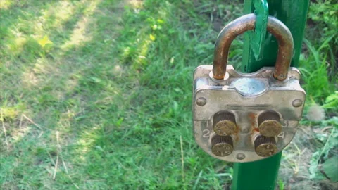 4-digit keyless door padlock. The iron doors are open. Stock Footage 166953960