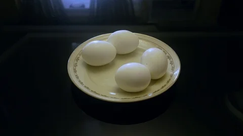 4 eggs on a platter, hand taking, left side Video stock 104195960