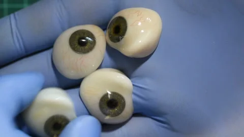 4 eye prostheses in the hand Stock Footage 91021800