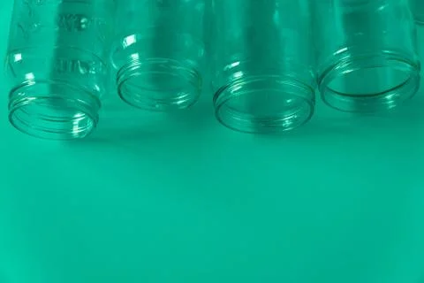 4 green glass jars on a green background with room for text Stock Photos