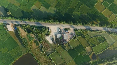 4 k Drone Shot: Roadside Industry and Logistics Hub in Lush Green Farmland. Stock Footage 318725348