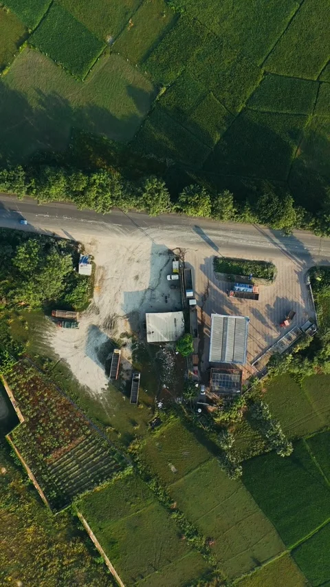 4 k Drone Shot: Roadside Industry and Logistics Hub in Lush Green Farmland. Stock Footage 318725595