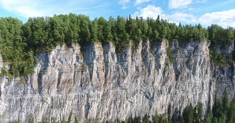 4 k flying approaching a cliff above the river Stockbeeldmateriaal 73299895