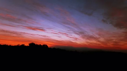  4 K. Sunset over trees  in red  and blue sky with clouds.  Time lapse   Stock-Footage 70347395