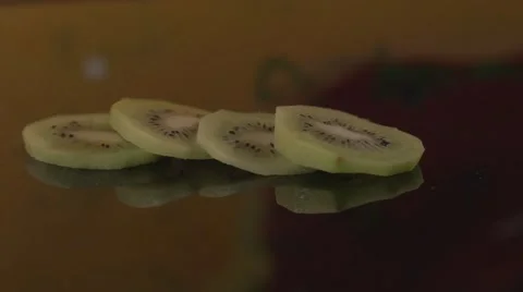 4 kiwi slices on the table Stock Footage 62598024