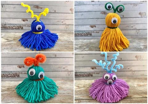 4 multi-colored, funny monsters with funny eyes, made of yarn, children's craft Stock Photos