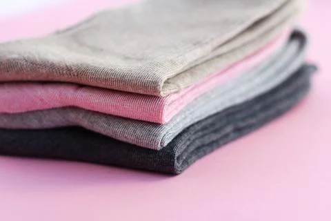4 pairs of multicolored cotton socks on a pink background. the concept of Stock Photos