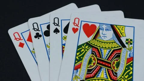 4 Queens in a row - Playing Cards, Isolated on black Stock Photos