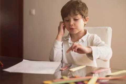 4-year-old boy does homework at home.He Does addition and subtraction operati Stock Photos