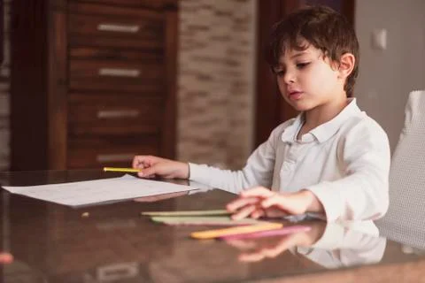 4-year-old boy does homework at home.He Does addition and subtraction operati Stock Photos