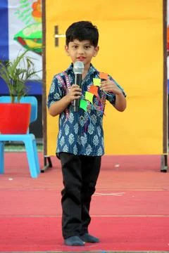 4 year old boy is performing on stage for elocution competition. Giving effectiv Stock Photos