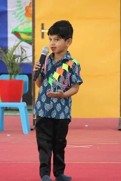 4 year old boy is performing on stage for elocution competition. Giving effectiv Stock Photos