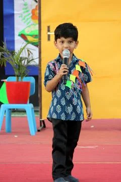 4 year old boy is performing on stage for elocution competition. Giving effectiv Stock Photos