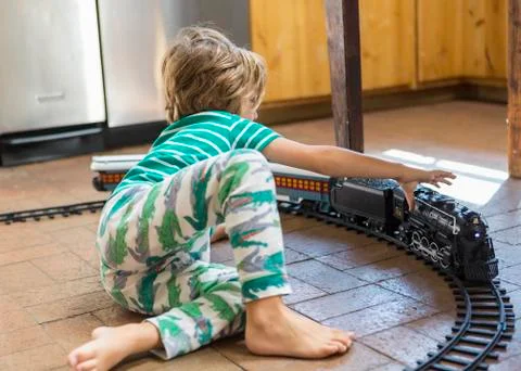 4 year old boy playing with toy train Stock Photos