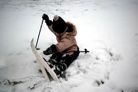 A 4 year old child learns to ski. Children's winter sport. Fun in the winter. Stock Photos