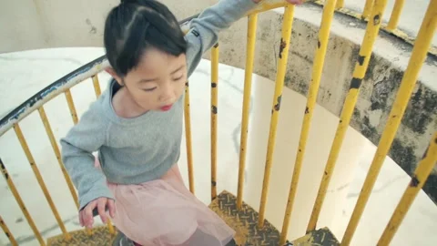 4-year-old kid climbing spiral stairs Video stock 161858476