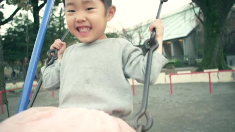4-year-old kid playing in a swing on a holiday Video stock 161858530