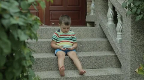 4 years old boy playing smartphone Stock Footage 48482905
