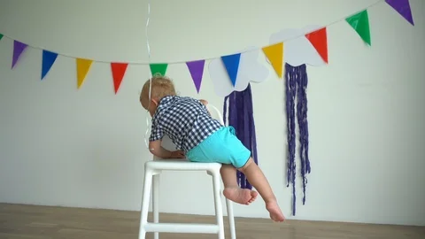 4 years old kid boy climb off high chair and walk away. Gimbal motion shot. Stock Footage 114769193