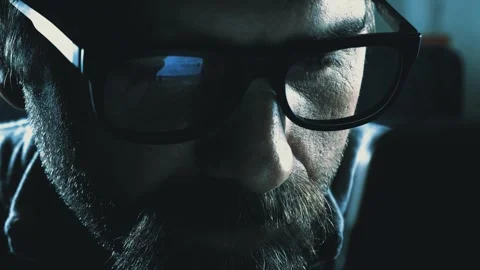 40-Year Man with Glasses Scrolling Phone in Dark Stock Footage 261734165