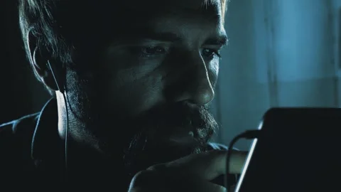 40-Year-Old Man Scrolling Phone in Dark Room Stock Footage 261733665
