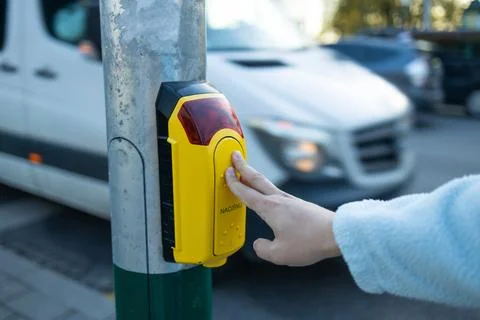 411A1035Pedestrian crossing button pressing the button, in urban street, with pe Stock Photos