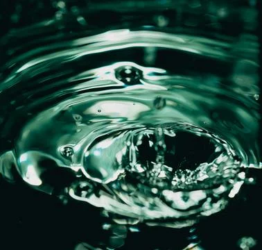 412.Liquid Crown Splash on Dark Surface Stock Photos