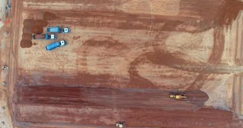 413 Dump trucks are moving down sand on construction site. road roller working Video stock 88925606