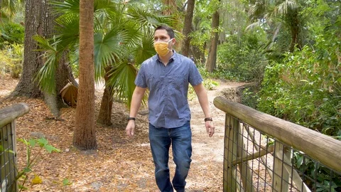 416 Man walking in a park with face mask Stock Footage 126719144