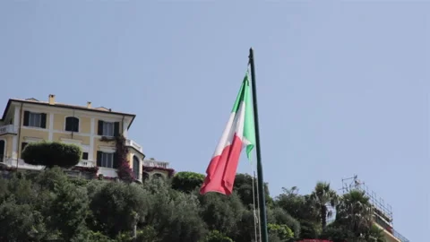 45 Italian flag blowing in the wind in italy on hot sunny day with blue sky's Stock Footage 131024376