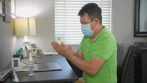 474 Office employee using hand sanitizer during COVID pandemic Video stock 133521018
