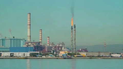 48663 Industrial Complex With Smokestacks and Flares Near Water During Clea.. Stock Footage 304169434