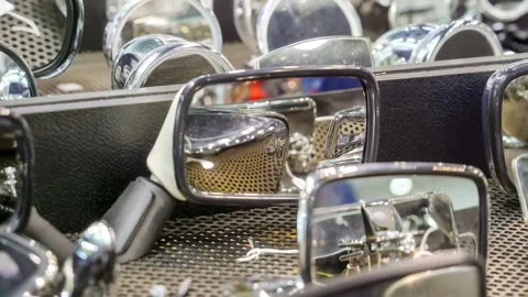 48677 Reflective Surfaces of Various Vehicle Side Mirrors Displayed in an A.. Stock Footage 304169663