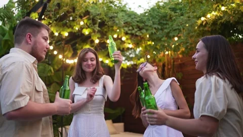 4K. 10 bit. Dancing at a summer party. Fun and joy of friends outside, bottles Stock Footage 161153061