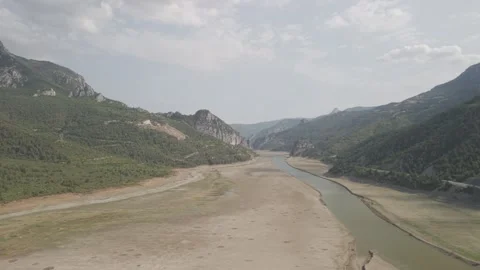 4K 10-bit drone shot flying forward low over a green river inside the giant Stock Footage 337649316